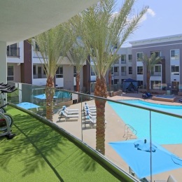 a balcony view of a courtyard with pool