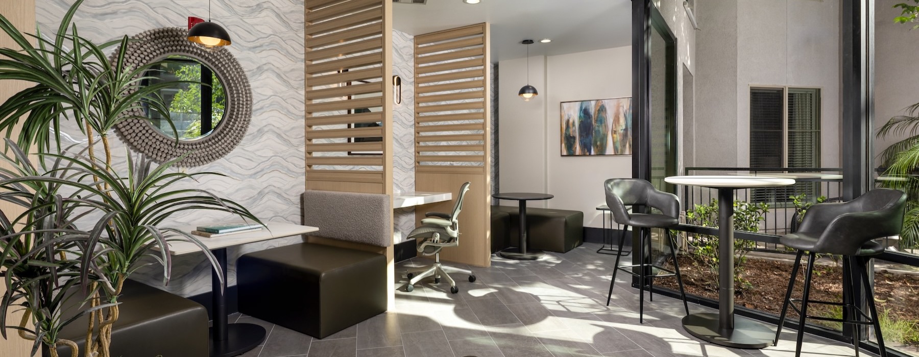 a room with a table chairs and a plant