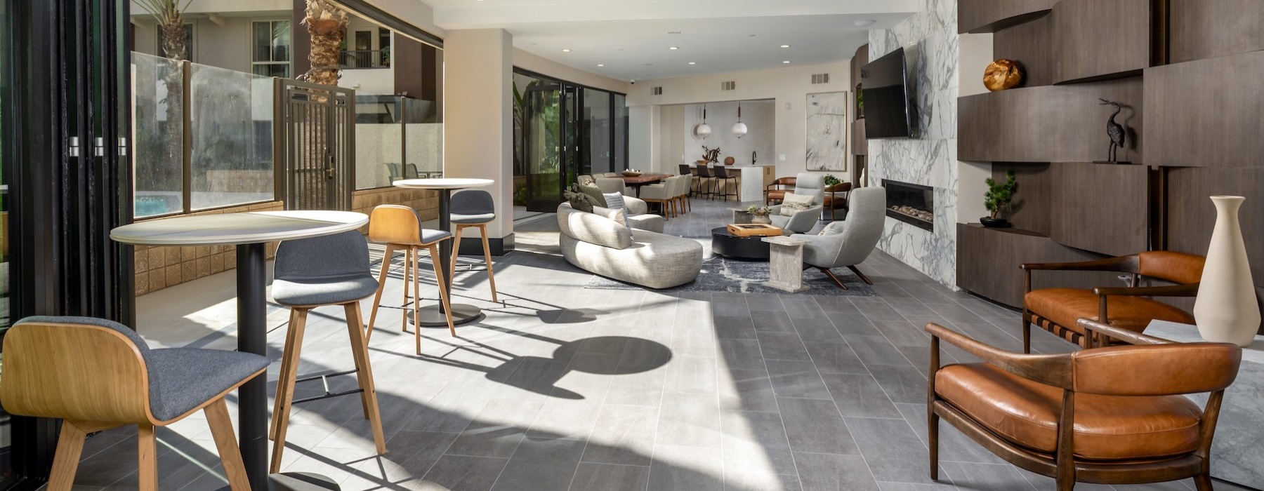 a clubroom with a table, chairs and a couch