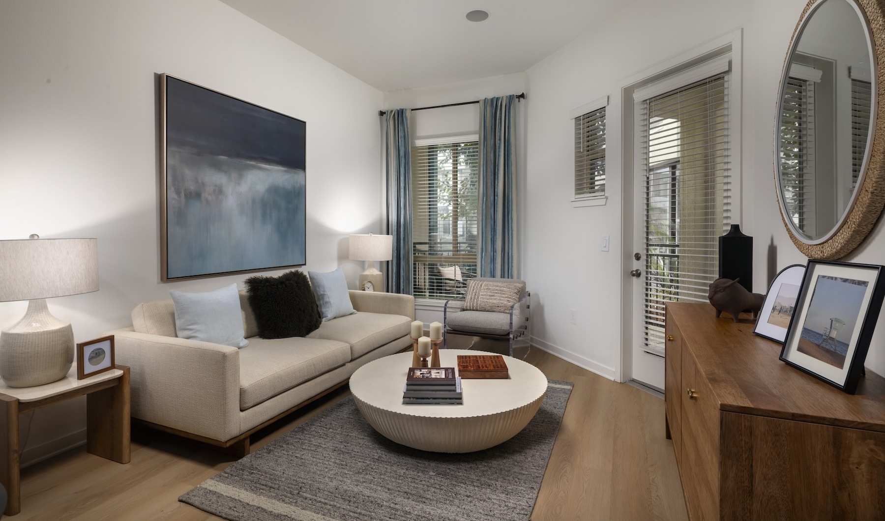 a living room with a couch, coffee table and painting